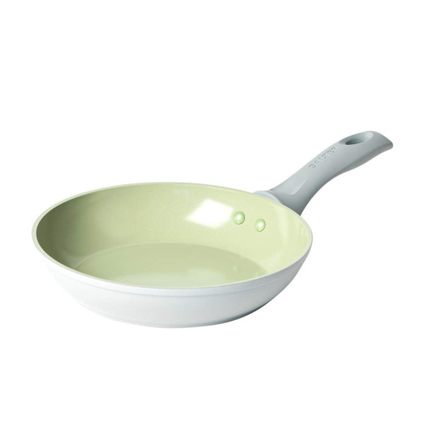 Set of pale green non-stick pans with food, overhead view