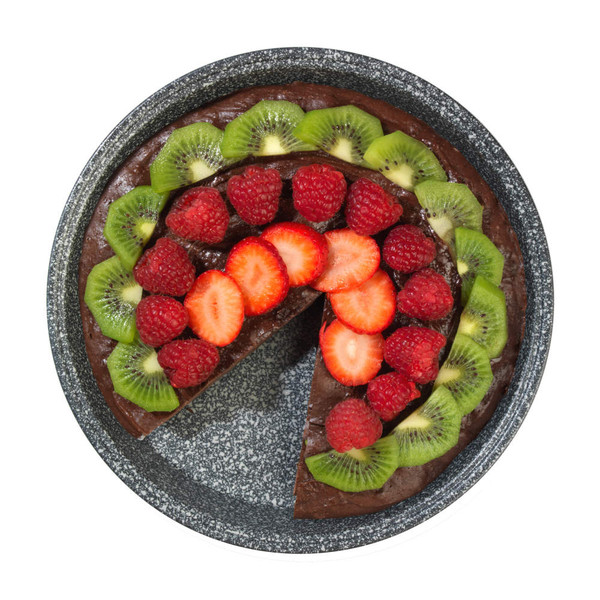 Chocolate cake with sliced kiwi, strawberries and raspberries on top, one slice missing