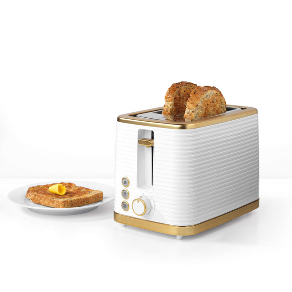 White and gold two-slice toaster with seeded bread and toast on plate