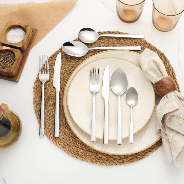 Eight-piece stainless steel cutlery set with knife, forks and spoons, displayed side by side
