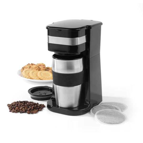 Black and silver single-serve coffee maker with travel mug, shown with coffee pods, beans and biscuits.