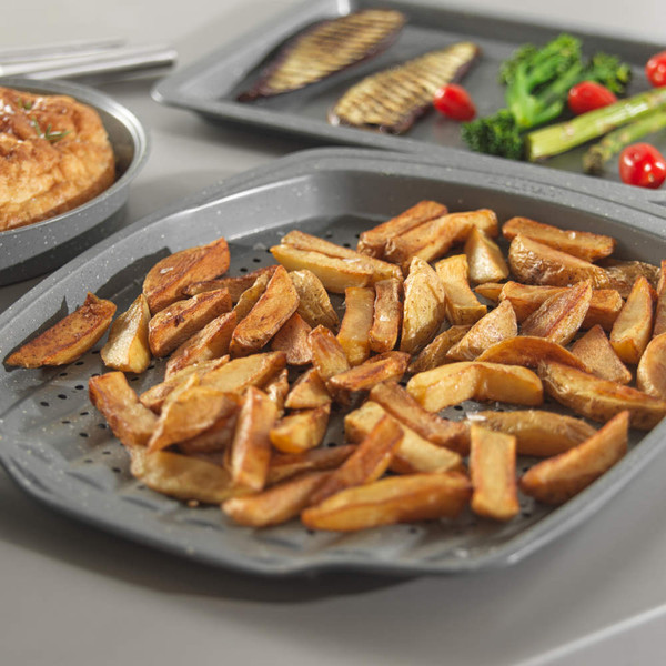 Grey oven tray with cooked potato wedges on kitchen worktop, marketing image for bakeware.