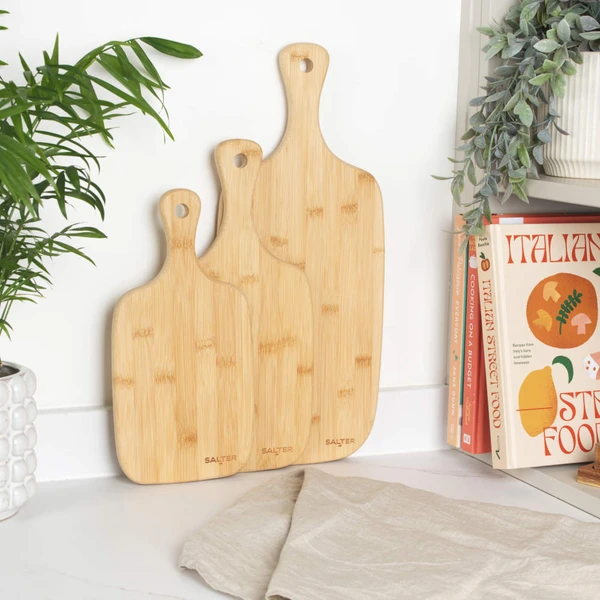 Set of three rectangular bamboo chopping boards with handles, plain finish.