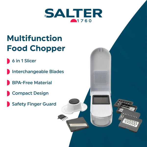 Hand using white food chopper to grate carrots into container in modern kitchen