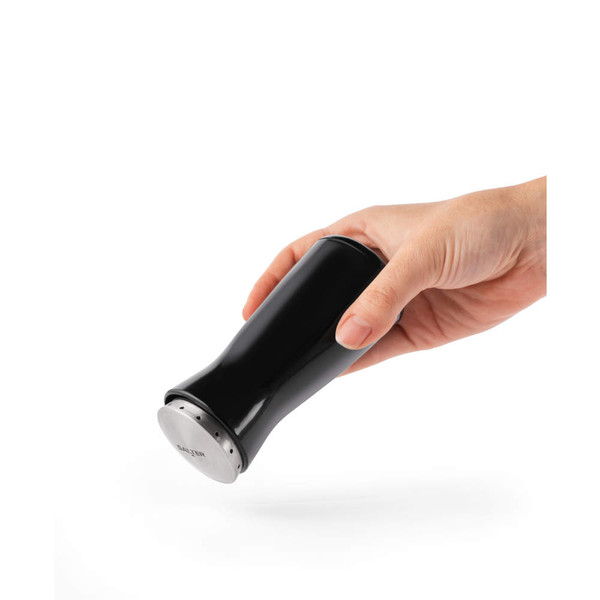 Black Salter salt shaker held in hand, angled for use