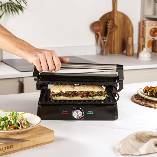 Product image: Salter Megastone health grill and panini maker shown open flat with cooked food.