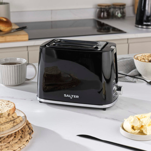 Black electric kettle with visible water gauge, Salter brand, finger switching it on