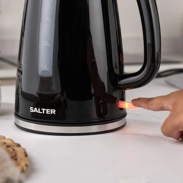 Black two-slice toaster with Salter branding, shown toasting brown bread in a kitchen.