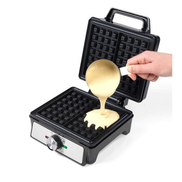 Black electric waffle maker with open lid, batter being poured onto plates