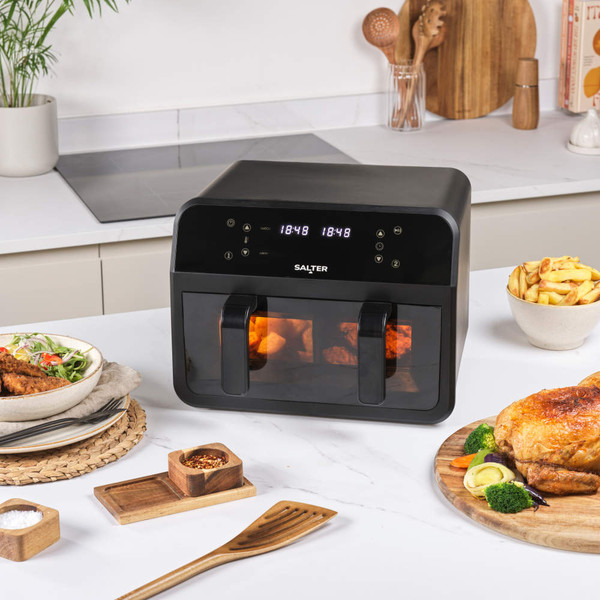 Black Salter air fryer with digital display, open basket with cooked roast potatoes