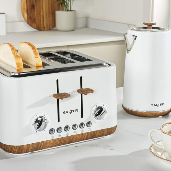 White 4-slice toaster with wooden accents on kitchen counter, hand adjusting controls
