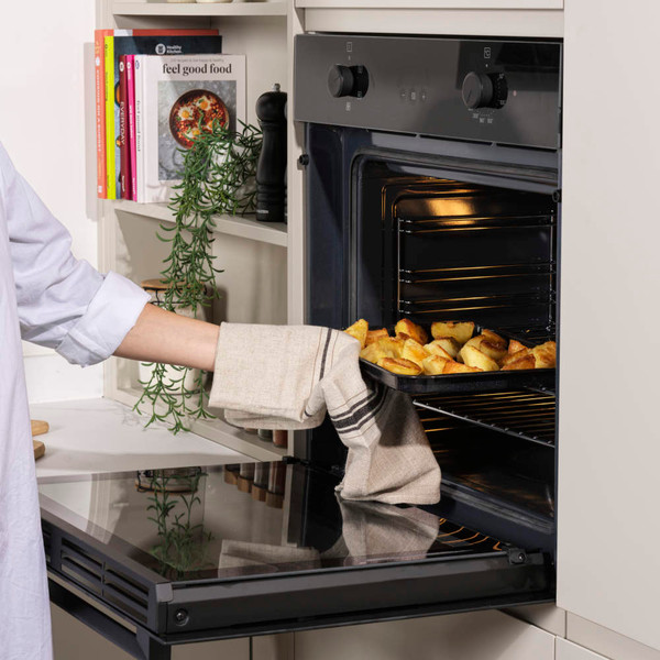 Large black roasting pan and lid loaded in dishwasher rack