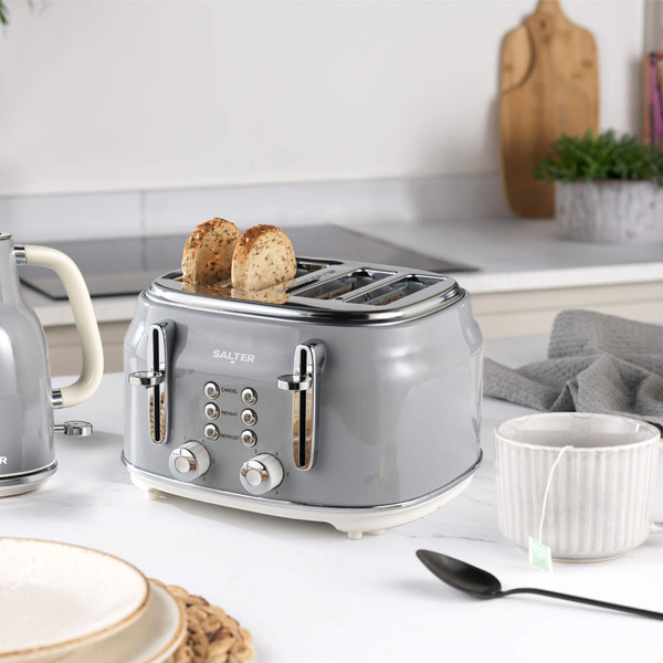 Grey Salter electric kettle, close-up view, shown pouring hot water into mug