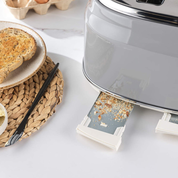 Grey toaster with removable crumb tray shown open on kitchen counter