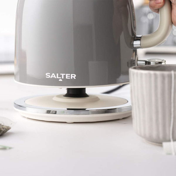 Grey Salter electric kettle, close-up view, shown pouring hot water into mug