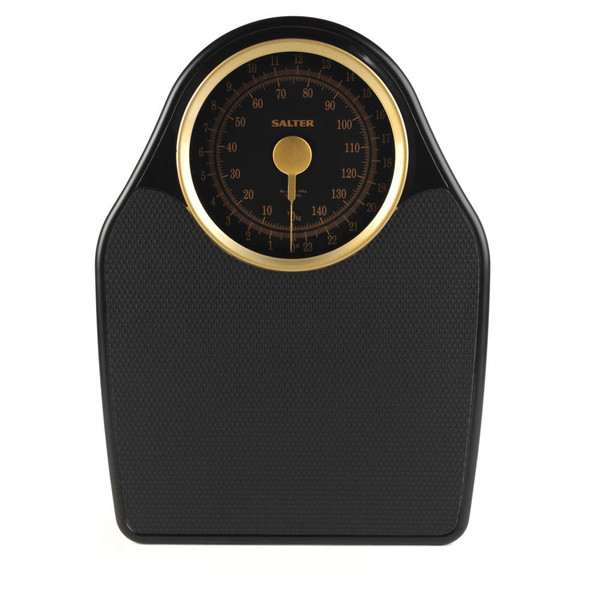Black and gold mechanical bathroom scale with textured platform, dial shows kilograms and stones