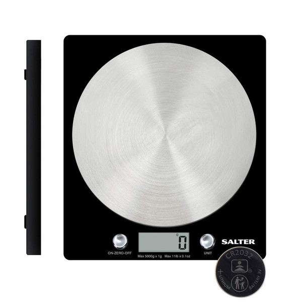 Digital kitchen scale weighing flour in glass bowl, baking ingredients nearby