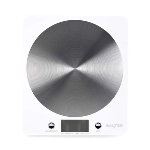 White digital kitchen scale with stainless steel platform on worktop, shown with baking ingredients