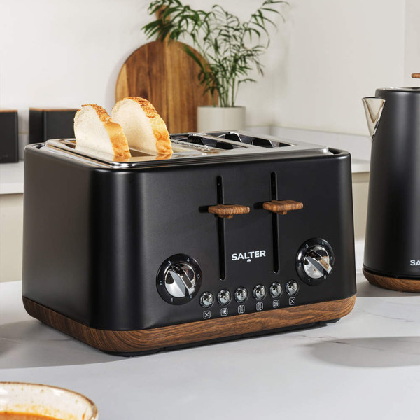 Black four-slice toaster with wood accents, showing toasted bread in a modern UK kitchen
