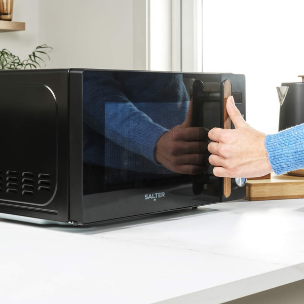 Black microwave oven with wood-effect handle, Salter branding, shown from front angle