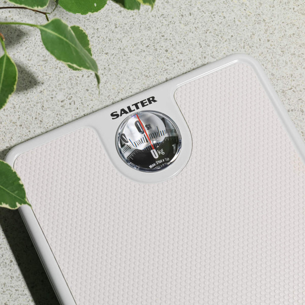 White mechanical bathroom scale with textured surface, showing Salter brand.