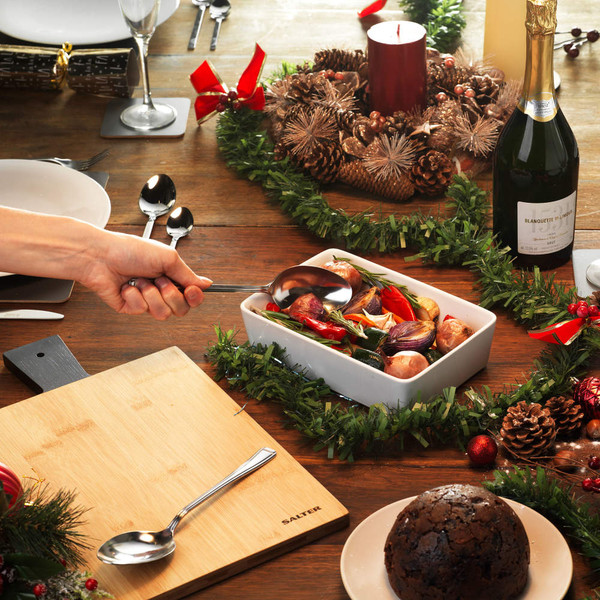 Set of four stainless steel cutlery pieces: fork, knife, dessert spoon, and teaspoon.