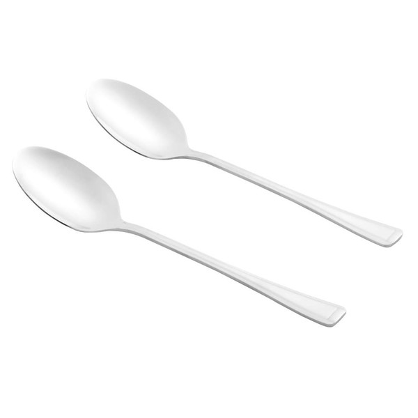Set of two stainless steel dessert spoons on woven placemat with bowl