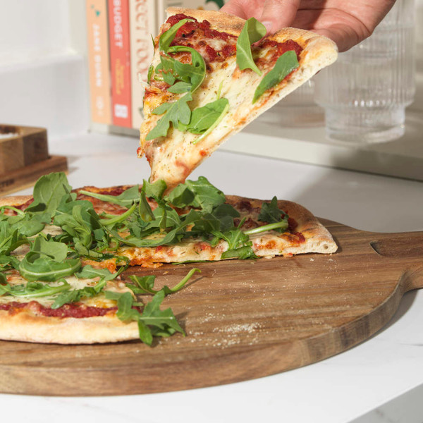 Round wooden serving board with handle, natural finish