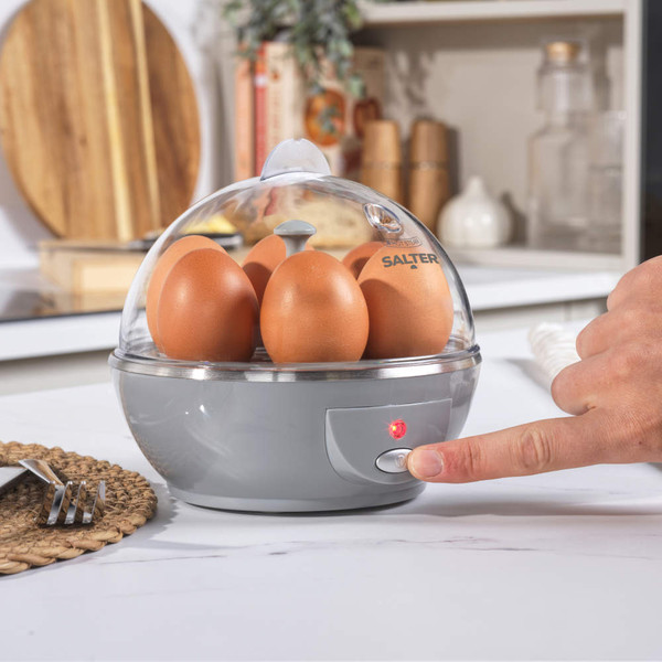 Egg cooker with six eggs on worktop, kitchen setting