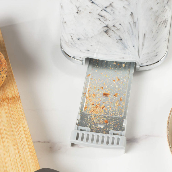 Toaster crumb tray pulled out, showing toasted crumbs for easy cleaning