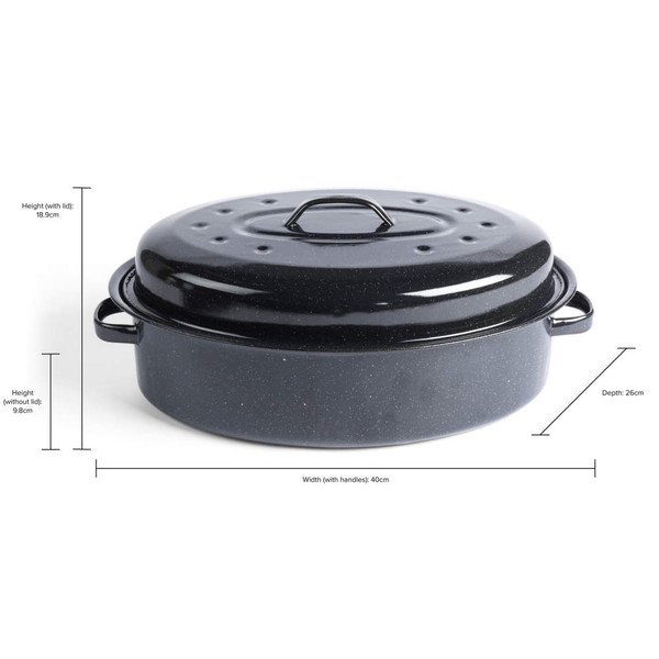 Black oval roasting tin with lid, shown with cooked ham inside on a kitchen worktop