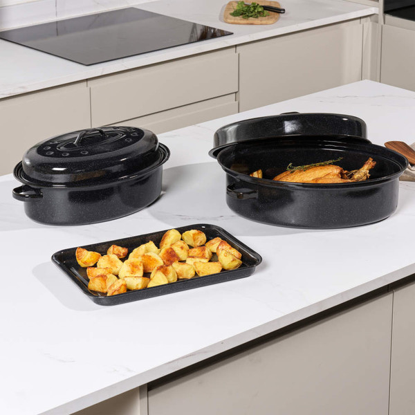 Black enamel roasting pan and lid in dishwasher, shown for cleaning suitability.