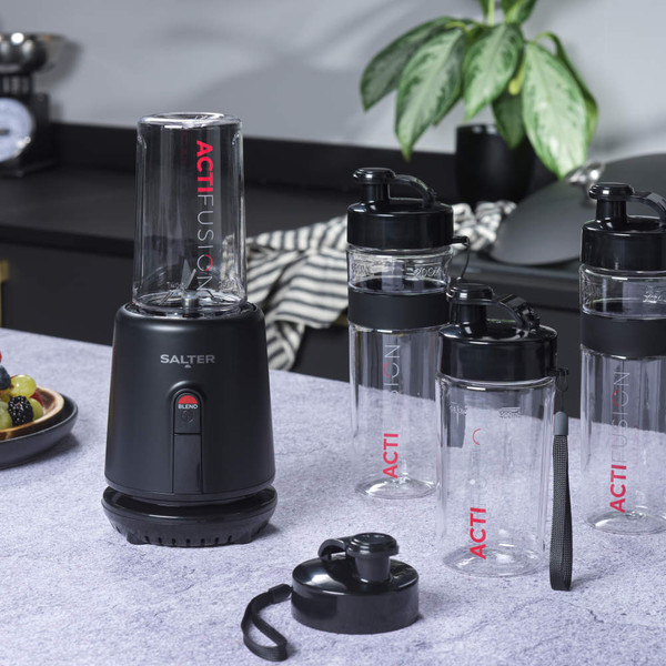 Black Salter blender kit with three clear sports bottles, one filled with fruit.