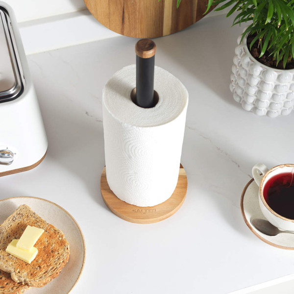 Bamboo and black kitchen roll holder on countertop, shown with toast and tea