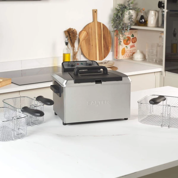 Salter stainless steel deep fryer with dual fry baskets on kitchen worktop
