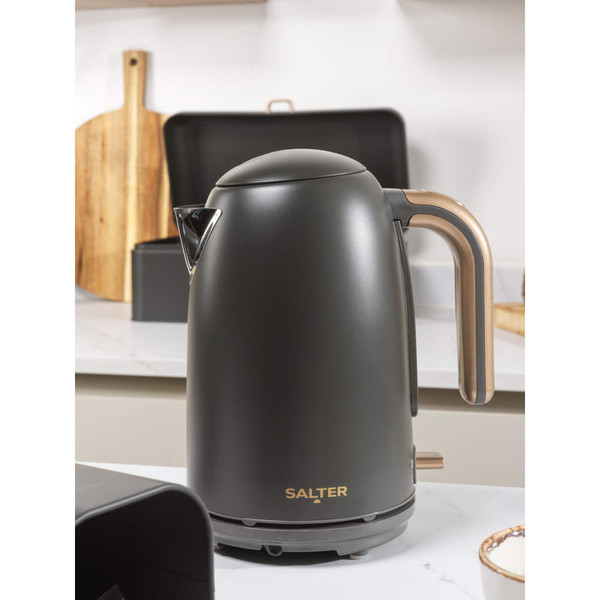 Grey electric kettle, viewed from the back with gold handle