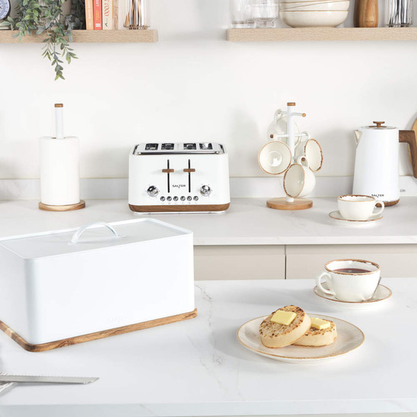White Salter toaster, kettle, bread bin and mugs on kitchen worktop, with crumpets and tea