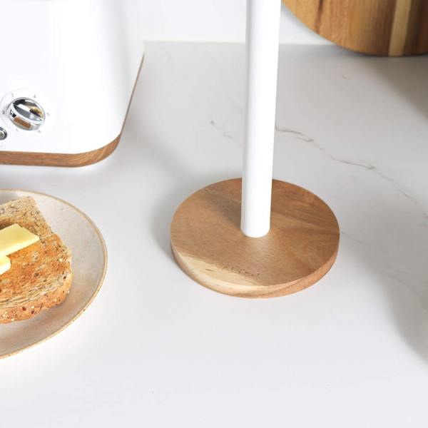Wood and white paper towel holder on kitchen worktop beside toaster and plate of toast