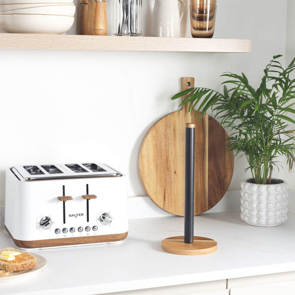 White four-slice toaster with wood accents on kitchen counter, next to wooden paper towel holder