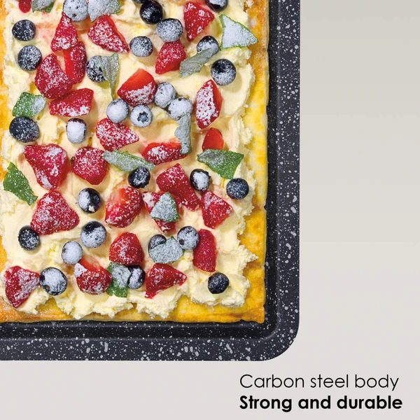 Rectangular carbon steel baking tray with fruit tart, showing its strong, durable body.