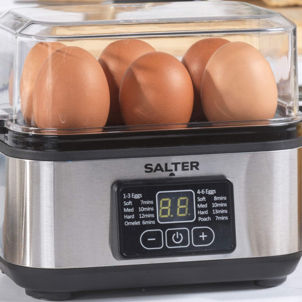 Egg boiler with six brown eggs in a clear lid on a Salter stainless steel base