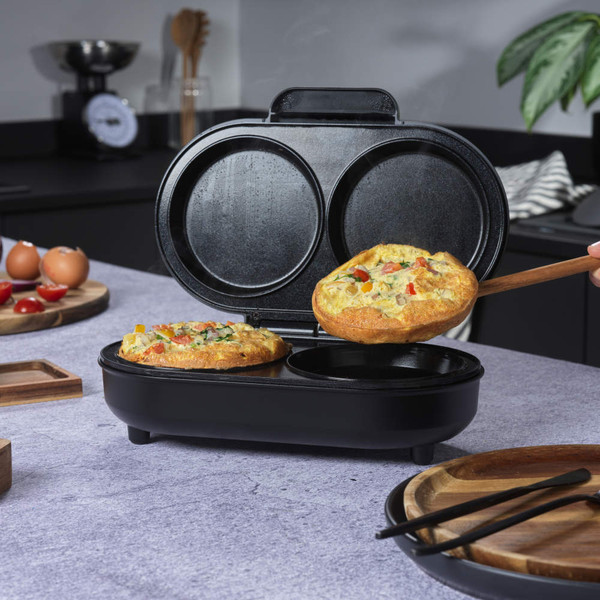 Black electric egg cooker with open lid showing two non-stick poaching trays