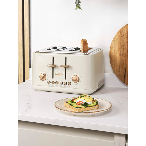 Cream 4-slice toaster with copper controls on kitchen counter, toast and poached egg