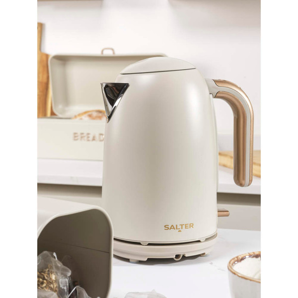 Cream 4-slice toaster with copper controls on kitchen counter, toast and poached egg