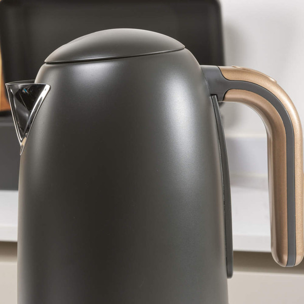 Matte black electric kettle with gold handle, shown on kitchen worktop.