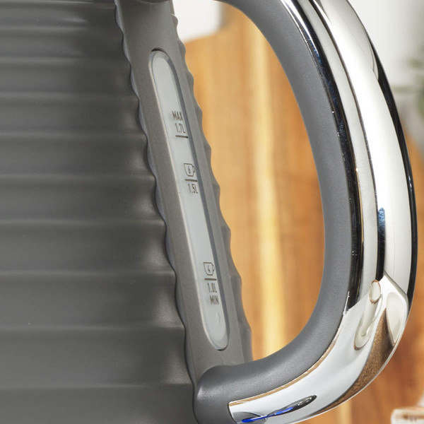 Close-up of dark grey kettle handle showing clear water level indicator