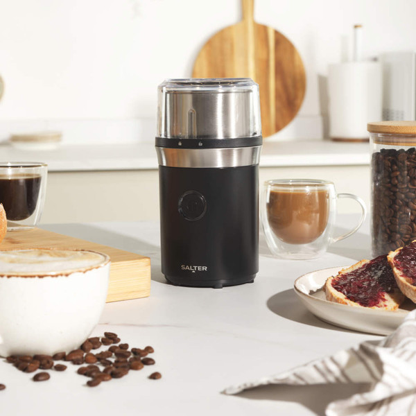 Black electric coffee grinder with stainless steel top, shown upright on white background
