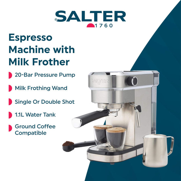 Stainless steel espresso machine with two espresso cups, milk jug and coffee grounds.