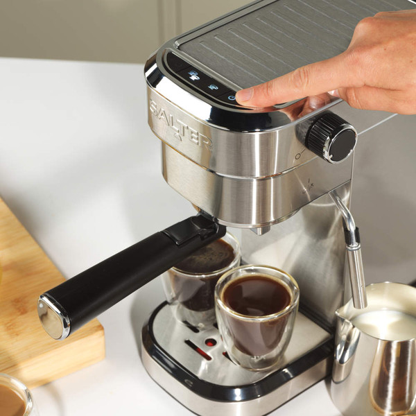 Silver espresso coffee machine with steam wand and milk jug, shown from the front.