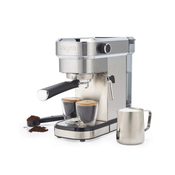 Stainless steel espresso machine with two espresso cups, milk jug and coffee grounds.
